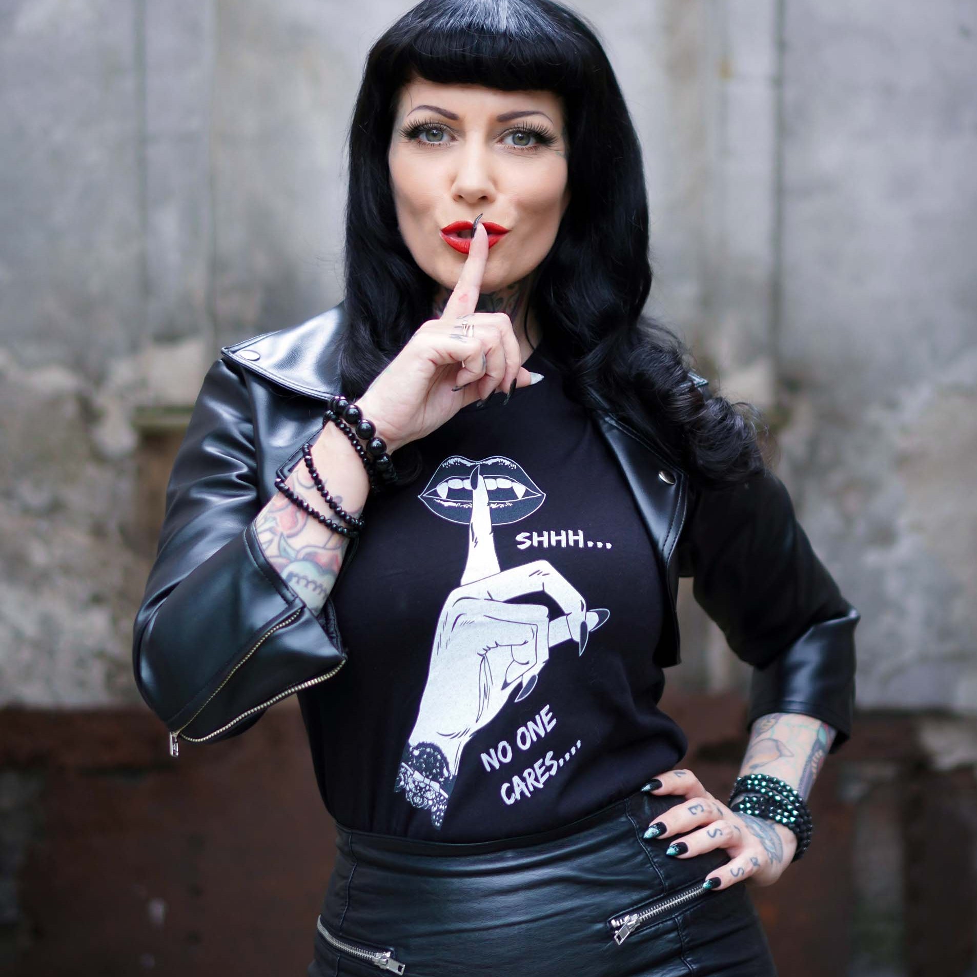 Rockabilly Goth girl wearing black goth t shirt that says Shhh...No one cares.