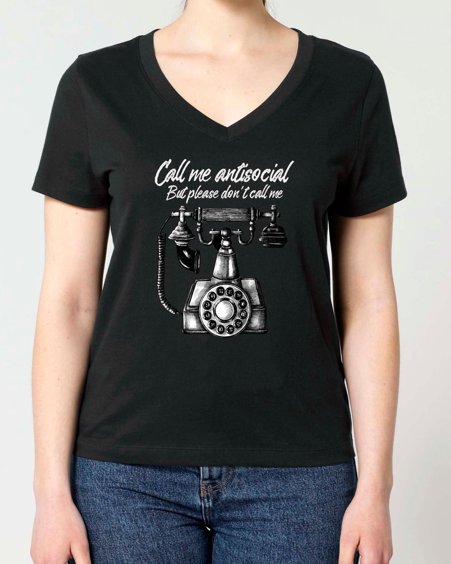 A woman modeling a black V-neck t-shirt with a Vintage graphic print of a rotary phone and the text 'Call me antisocial but please don't call me'.