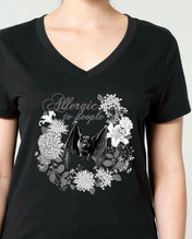 A woman modeling a black V-neck t-shirt with a Vintage style monochrome graphic print of a bat and flowers.